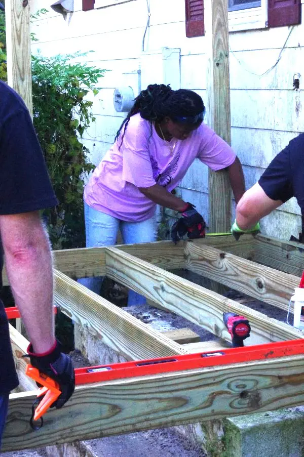 People working on a construction project assembling wooden frames.