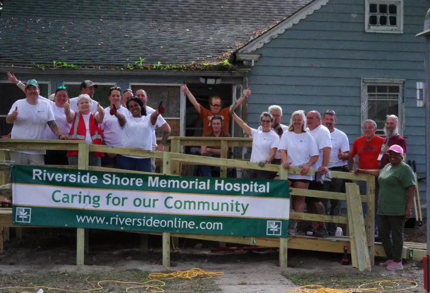 Group of healthcare workers posing outside Riverside Shore Memorial Hospital.