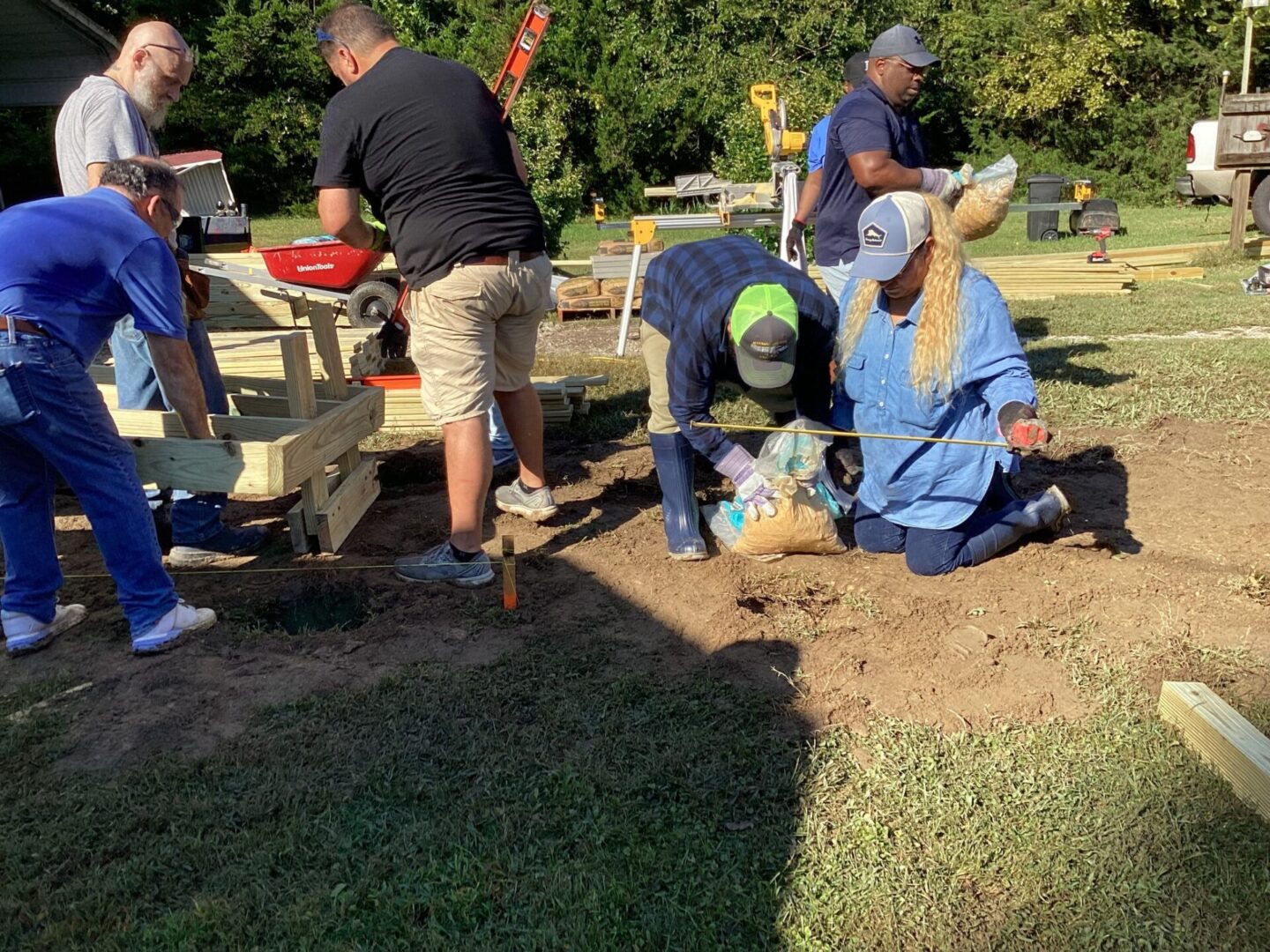 People engaged in an outdoor excavation or archaeological dig under the sun.
