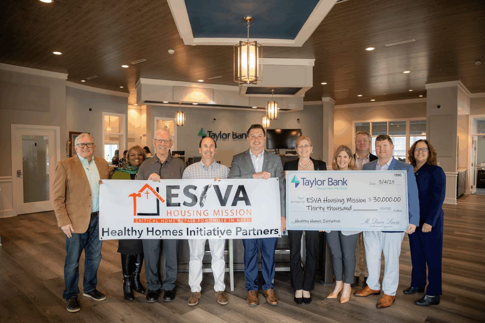 Group holding a large check for a community partnership.