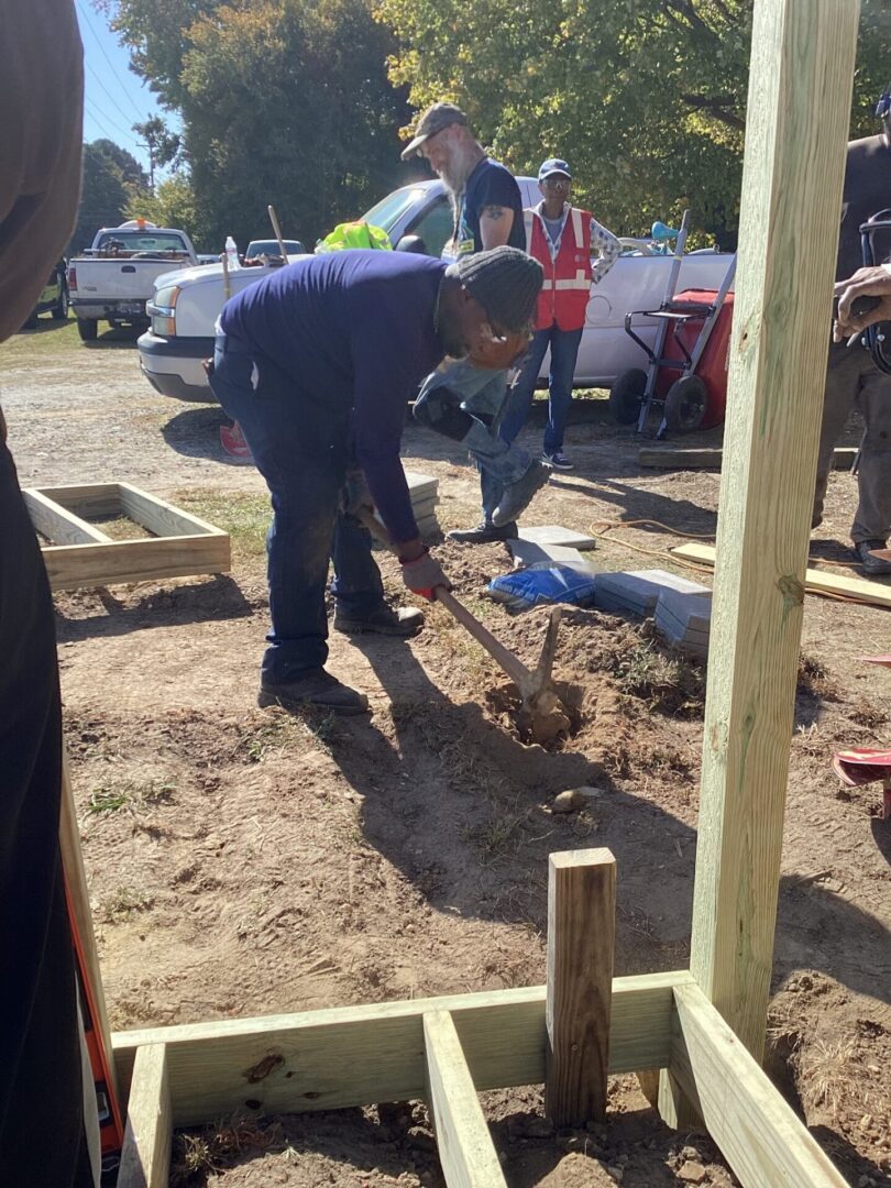 Construction workers digging a foundation at a building site.
